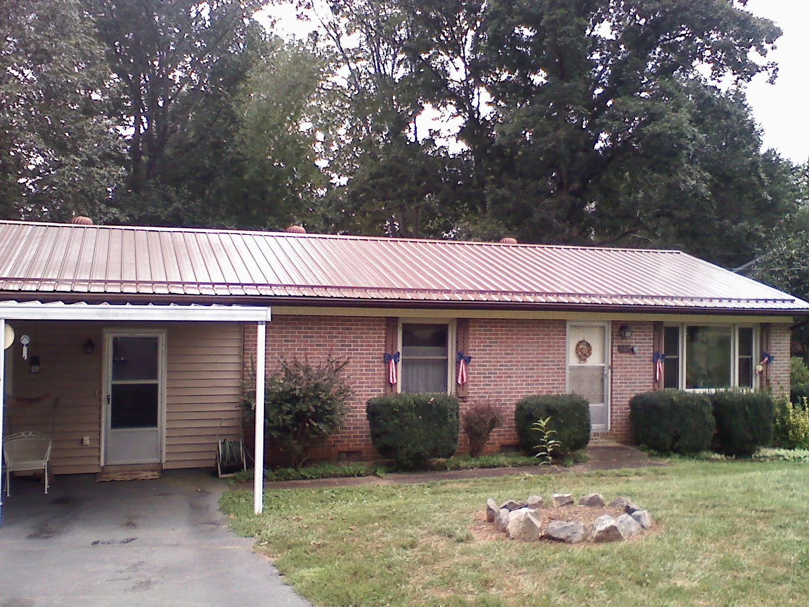 Bronze metal roof and carport on a brick ranch home — Roof Repair work by our crew in Crest Hill