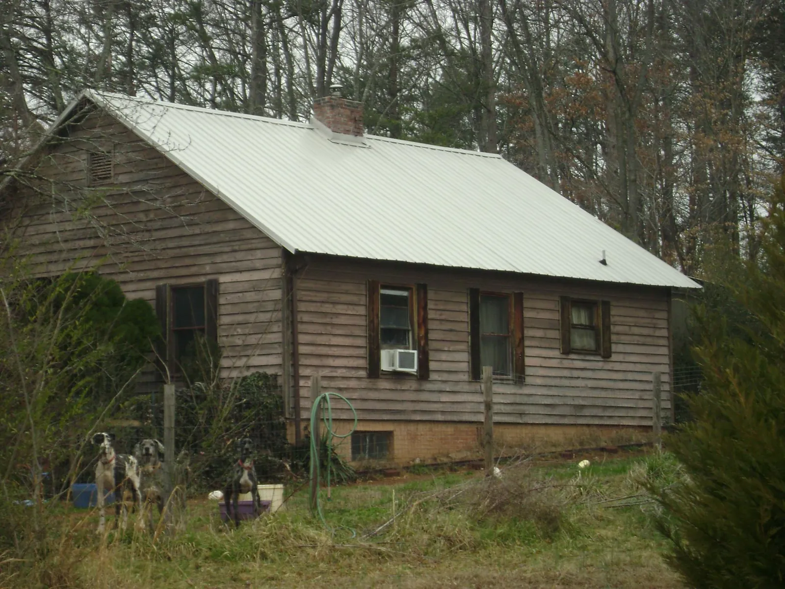White metal roof on an old wood sided farmhouse, from a Metal Roof Installation job in Crest Hill